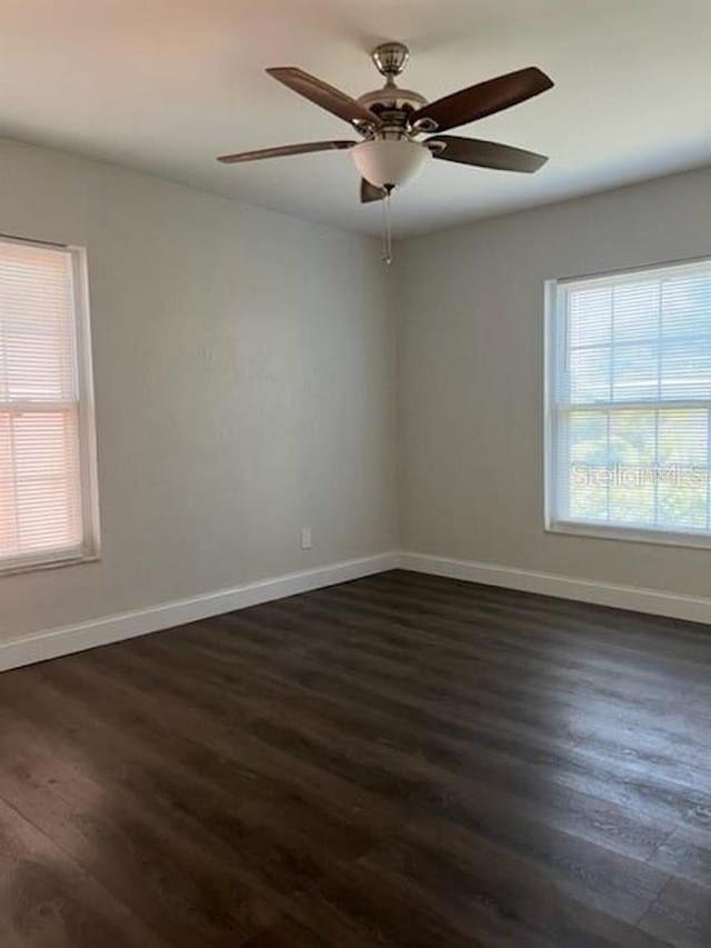 spare room featuring dark hardwood / wood-style floors and ceiling fan