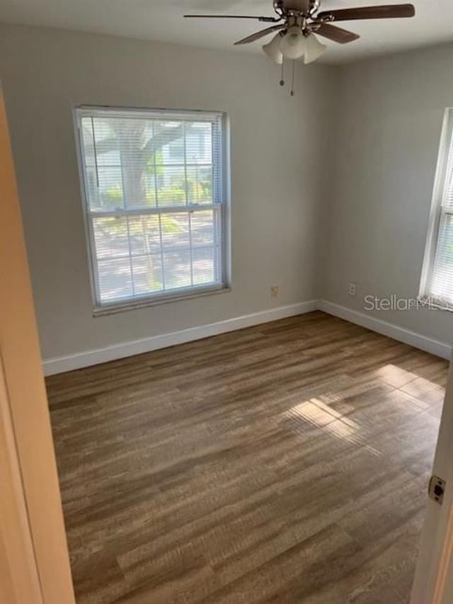 spare room featuring ceiling fan and a healthy amount of sunlight