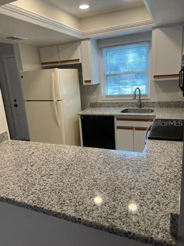 kitchen with sink, stove, black dishwasher, white cabinets, and white fridge