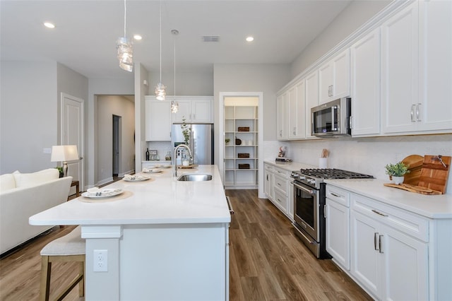 kitchen with sink, white cabinetry, appliances with stainless steel finishes, and tasteful backsplash