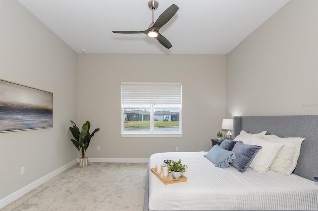 bedroom with ceiling fan and light carpet