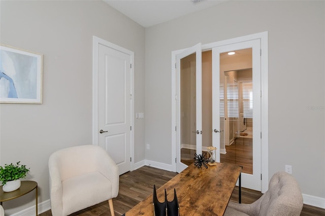 living area featuring french doors and dark hardwood / wood-style floors