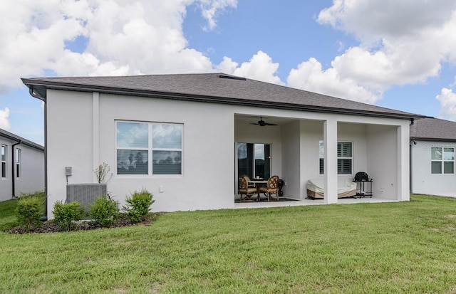 back of house featuring ceiling fan, cooling unit, a lawn, and a patio