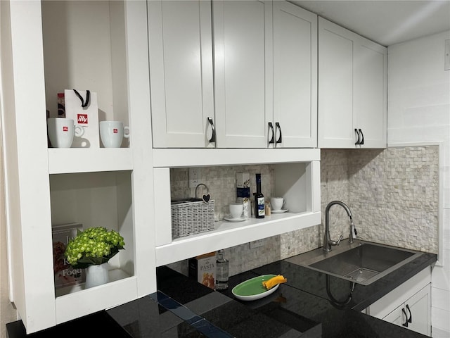 interior space featuring sink, white cabinets, and decorative backsplash