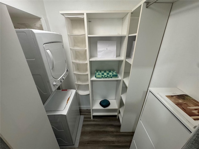 interior space with dark hardwood / wood-style floors and stacked washer and clothes dryer