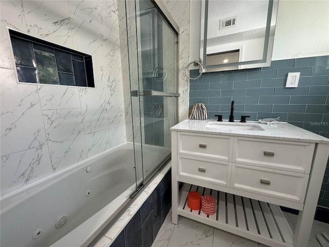 bathroom with bath / shower combo with glass door and vanity