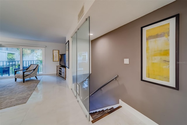 corridor featuring light tile patterned floors