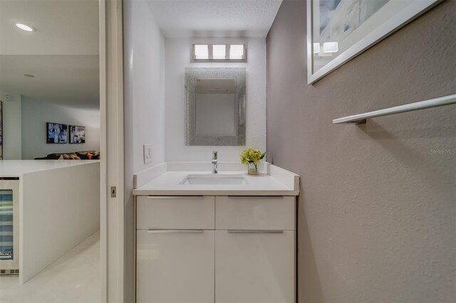 bathroom featuring a textured ceiling and vanity