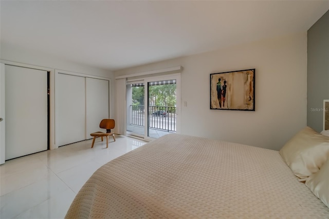 tiled bedroom featuring a closet and access to outside