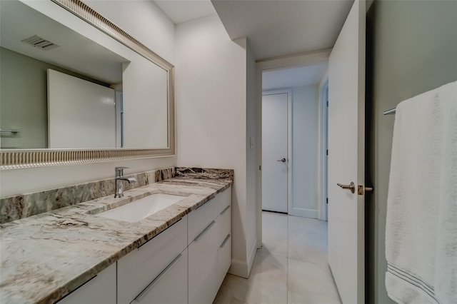 bathroom with tile patterned flooring and vanity