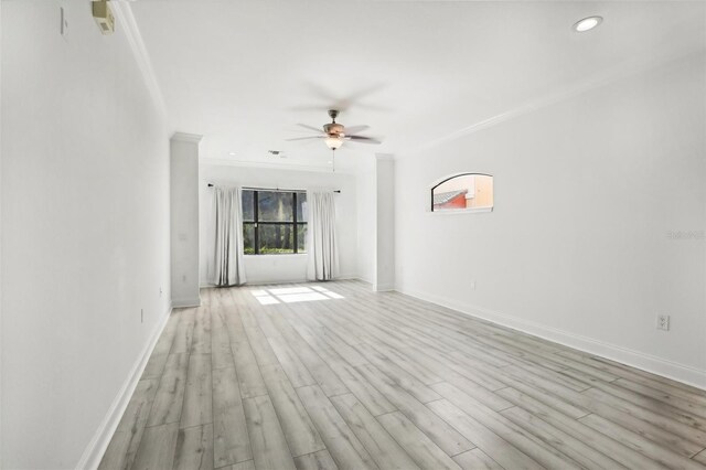 unfurnished living room featuring ornamental molding, ceiling fan, and light hardwood / wood-style flooring