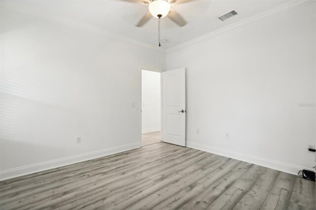 spare room with ornamental molding, ceiling fan, and light wood-type flooring