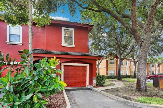 2272 Chianti Pl Unit 4-0048, Palm Harbor, FL 34683 - view of front of property featuring a garage, asphalt driveway, and stucco siding