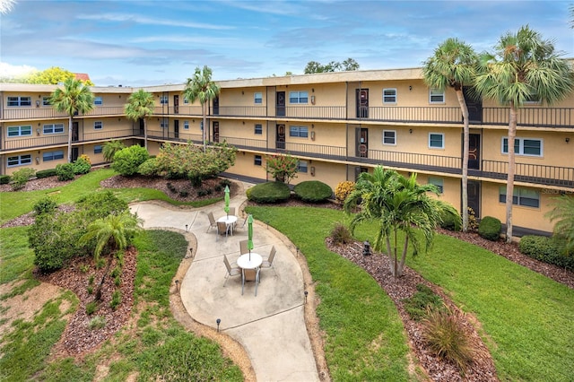 surrounding community featuring a patio and a lawn