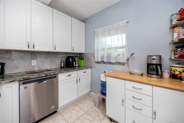 kitchen with light tile patterned flooring, stainless steel dishwasher, white cabinetry, and tasteful backsplash