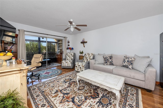 living room featuring a textured ceiling, ceiling fan, and hardwood / wood-style floors