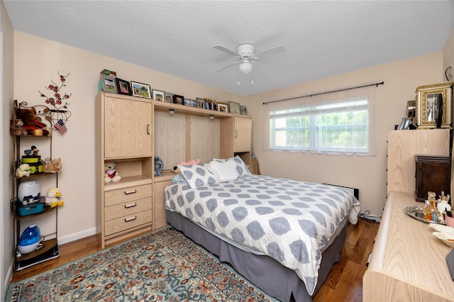 bedroom featuring wood-type flooring, a textured ceiling, and ceiling fan