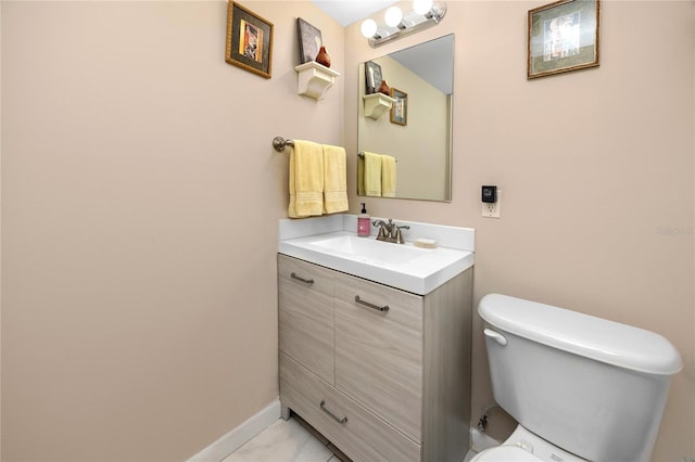 bathroom featuring vanity, tile patterned flooring, and toilet