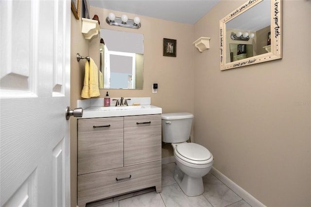 bathroom featuring vanity, tile patterned floors, and toilet