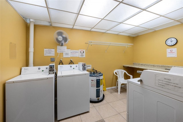 laundry area with light tile patterned flooring and washing machine and dryer