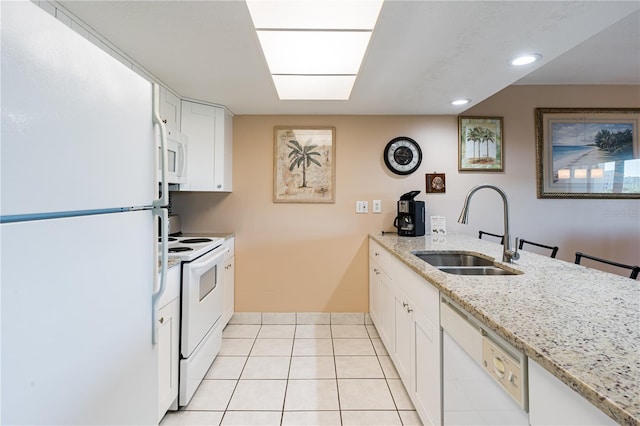 kitchen featuring sink, white cabinetry, light tile patterned floors, white appliances, and light stone countertops