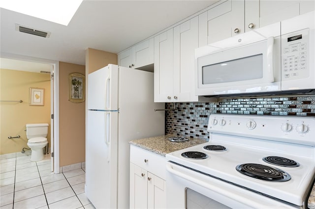 kitchen featuring white cabinetry, light tile patterned floors, white appliances, and decorative backsplash