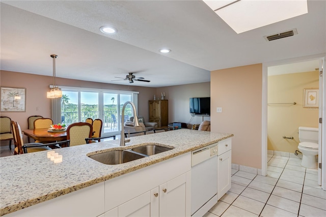 kitchen with white cabinetry, dishwasher, sink, hanging light fixtures, and light stone countertops