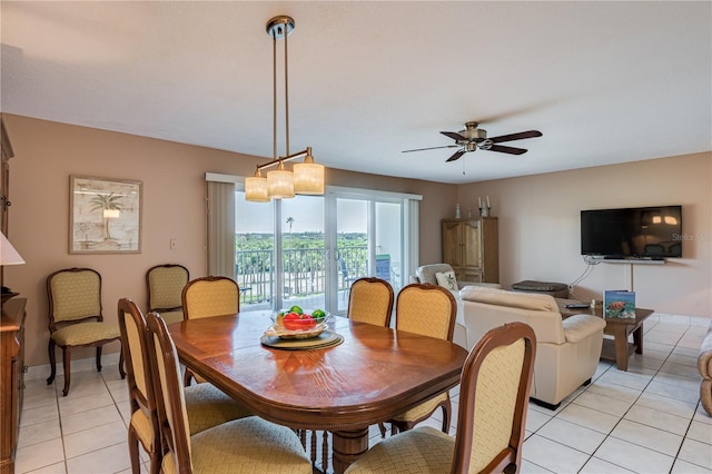 tiled dining room featuring ceiling fan