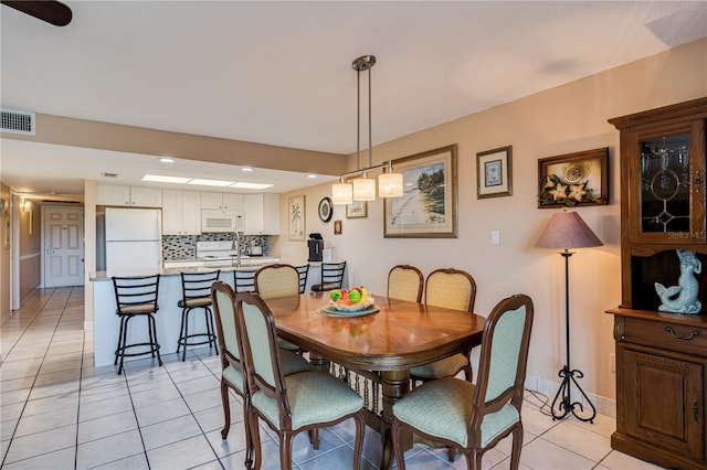 dining space featuring light tile patterned floors