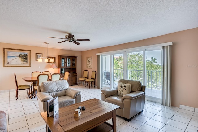 tiled living room with ceiling fan and a textured ceiling