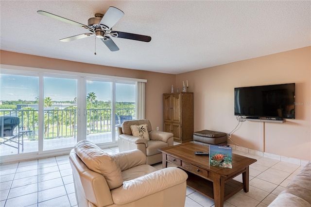 tiled living room featuring ceiling fan and a textured ceiling