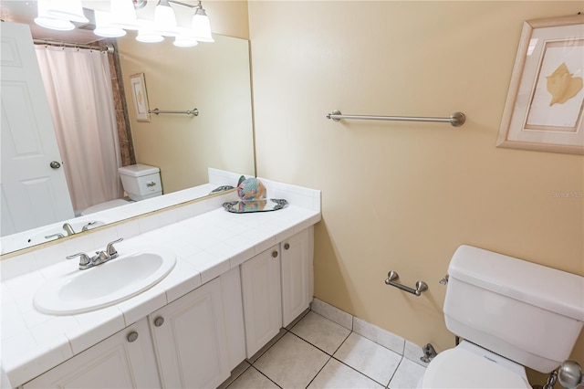 bathroom with tile patterned floors, toilet, curtained shower, and vanity