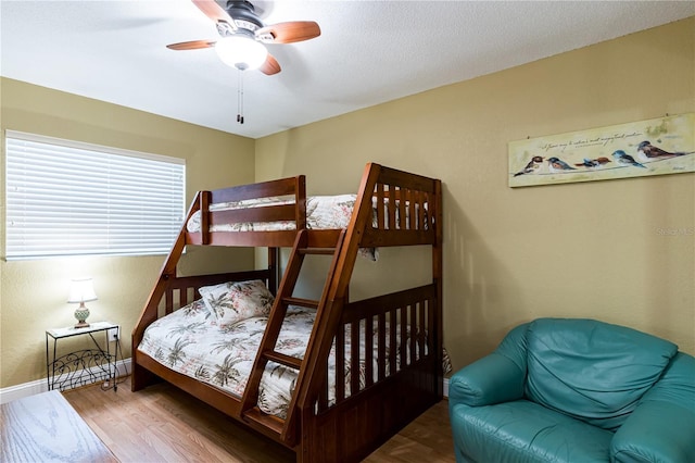 bedroom with wood-type flooring and ceiling fan