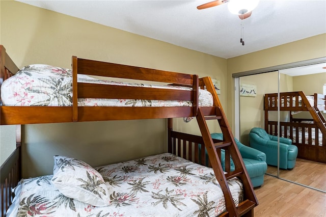 bedroom with light hardwood / wood-style flooring, a closet, and ceiling fan