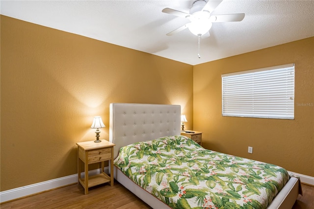 bedroom with ceiling fan and wood-type flooring