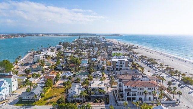 birds eye view of property featuring a water view and a beach view