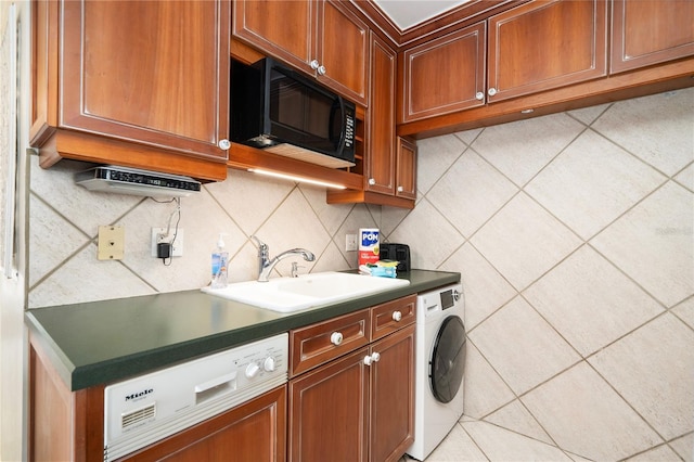 kitchen with dishwashing machine, washer / dryer, sink, and backsplash