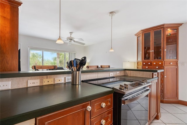 kitchen with ceiling fan, decorative light fixtures, stainless steel range with electric cooktop, and light tile patterned floors