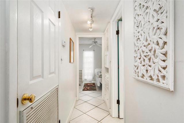 hall with light tile patterned floors