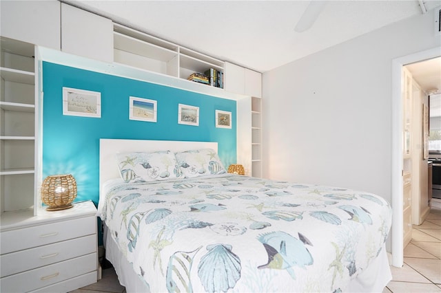 tiled bedroom featuring ceiling fan