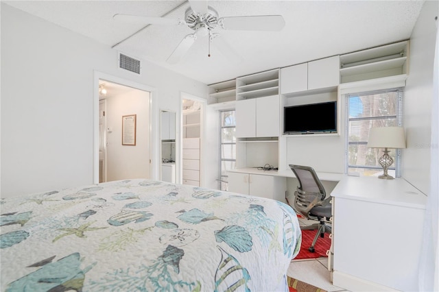 bedroom with built in desk and ceiling fan