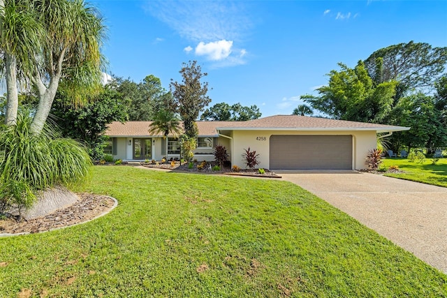 ranch-style home featuring a garage and a front lawn