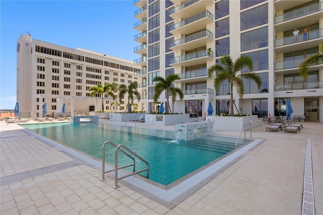 view of swimming pool featuring pool water feature and a patio area