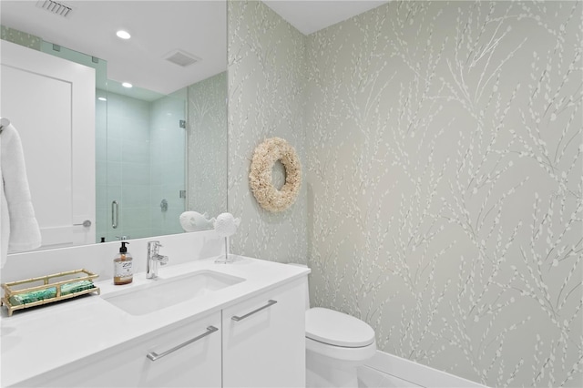 bathroom featuring an enclosed shower, vanity, tile patterned floors, and toilet