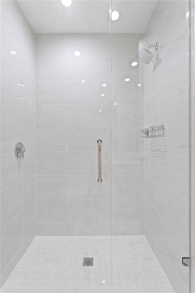 bathroom with a shower with door