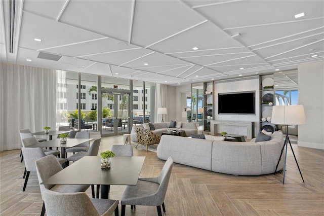 living room with french doors, a wall of windows, light parquet flooring, and plenty of natural light