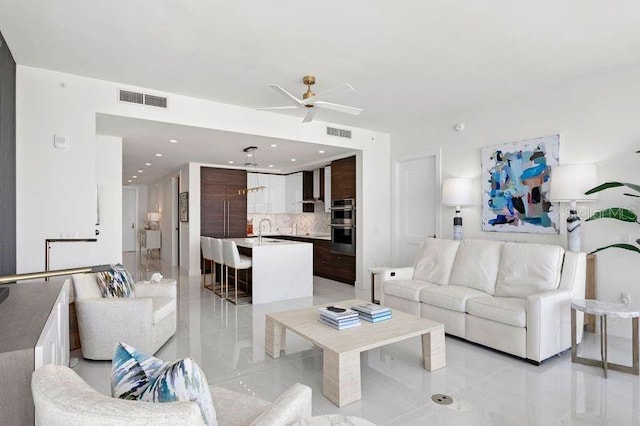 living room featuring sink and ceiling fan