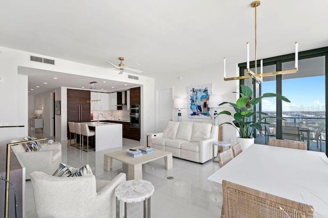 living room with ceiling fan and sink