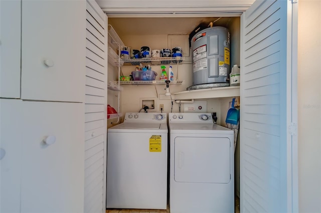 clothes washing area with separate washer and dryer and water heater