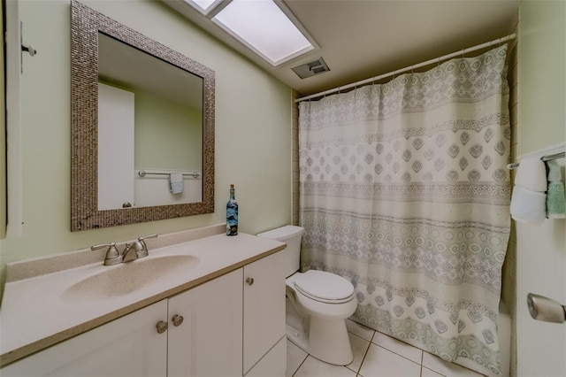 bathroom with vanity, tile patterned flooring, and toilet